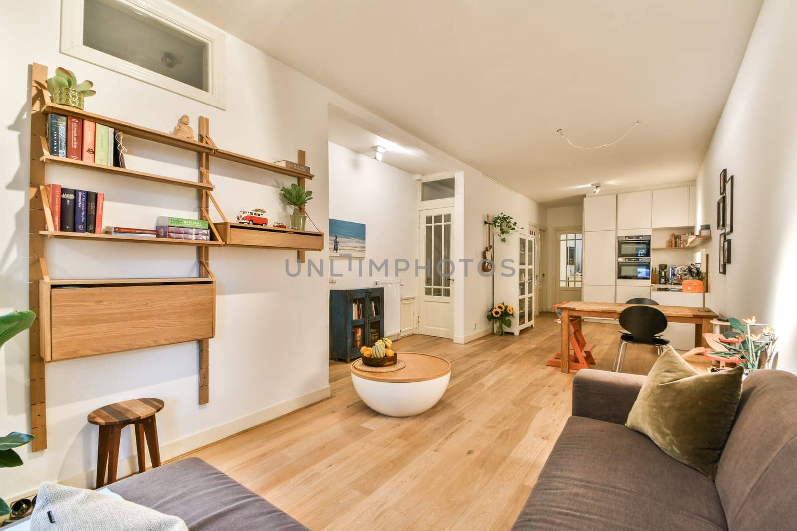 A cozy and modern living space featuring minimalist furniture, warm tones, and decorative plants, creating a tranquil atmosphere for relaxation.
