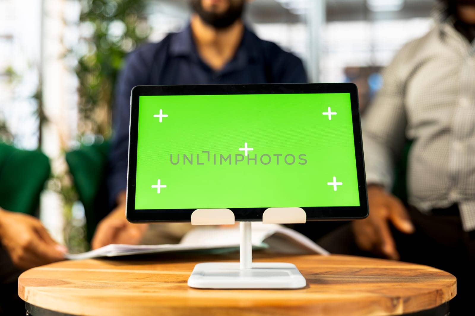 Board of directors in office maintaining strong relationships with business partners, looking at metrics on green screen tablet. Company director shows shareholders data on chroma key device, closeup