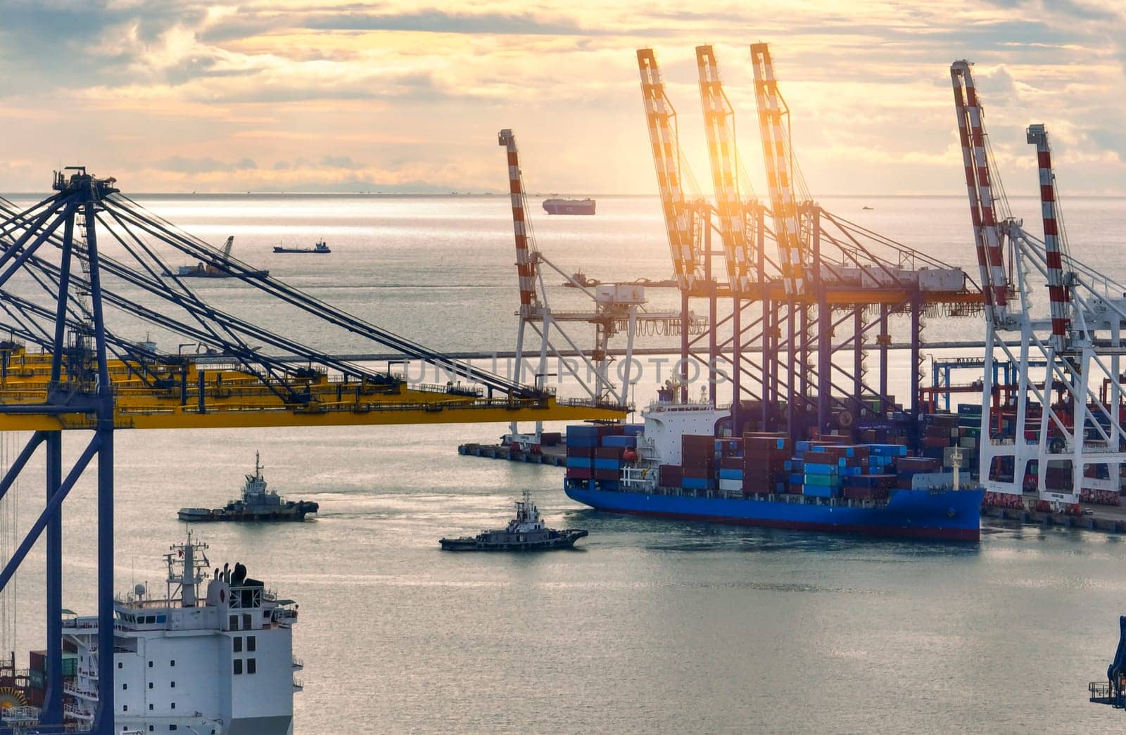 Logistics and transportation of container cargo ship at ship port. Container truck and crane bridge in shipyard. Import export and transport industry. Terminal port for export transport by ship.
