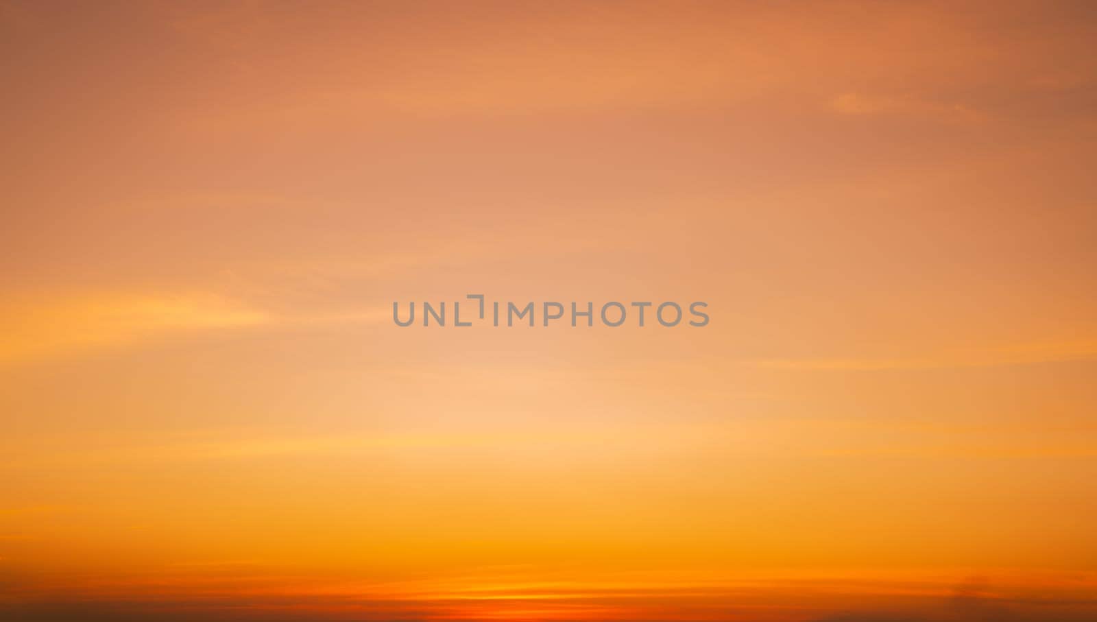 Calming orange sunset glows above peaceful horizon in summer. Peaceful sky at dusk create serene atmosphere for relaxation meditation background nature landscape scenic view summer evening tranquility