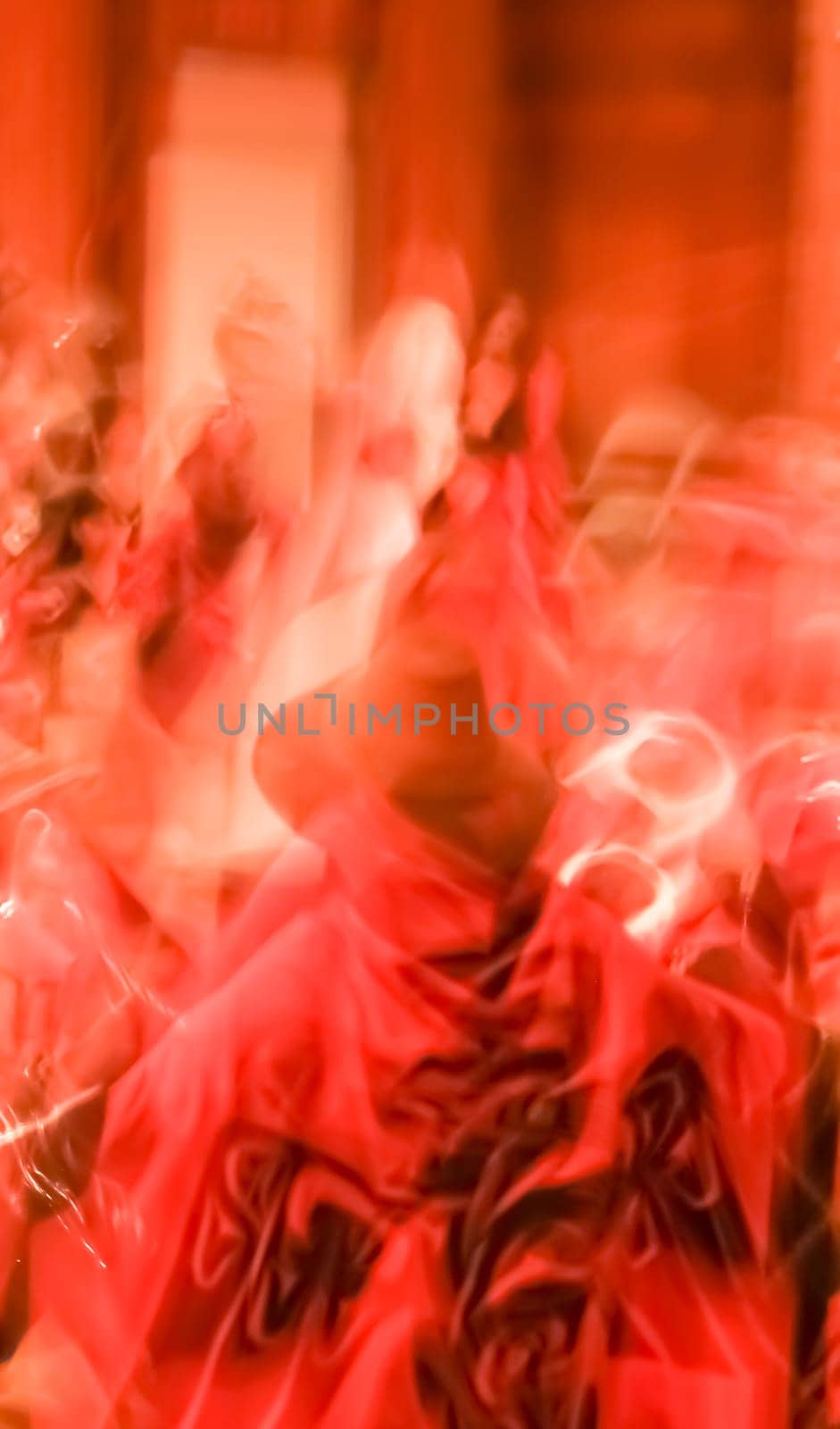 Background imagery of red motion and colour fusion swirling dance effect.