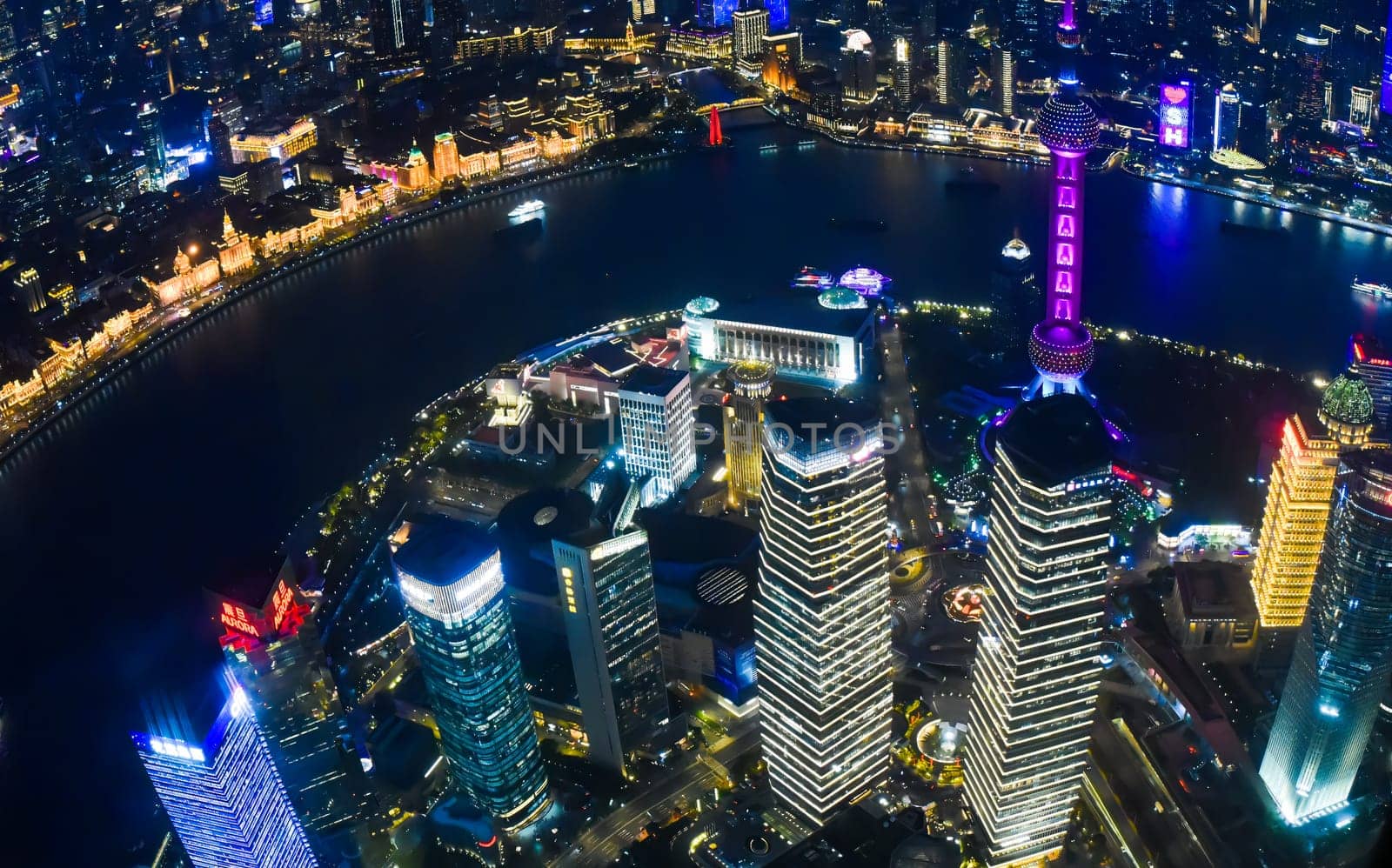 Shanghai, China - 1 April 2025: A stunning night view from Shanghai Tower, capturing the Oriental Pearl Tower, Huangpu River, Pudong district, and Shanghai World Financial Center