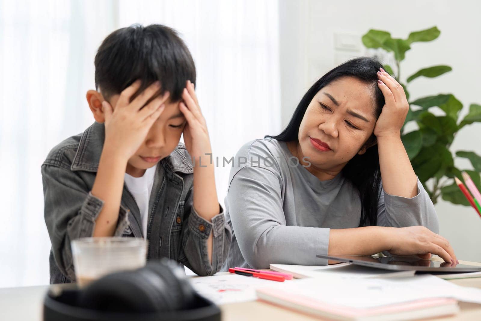 A mother notices her son feeling overwhelmed with his studies and offers comfort and support. She provides a reassuring presence to help him through challenging moments.