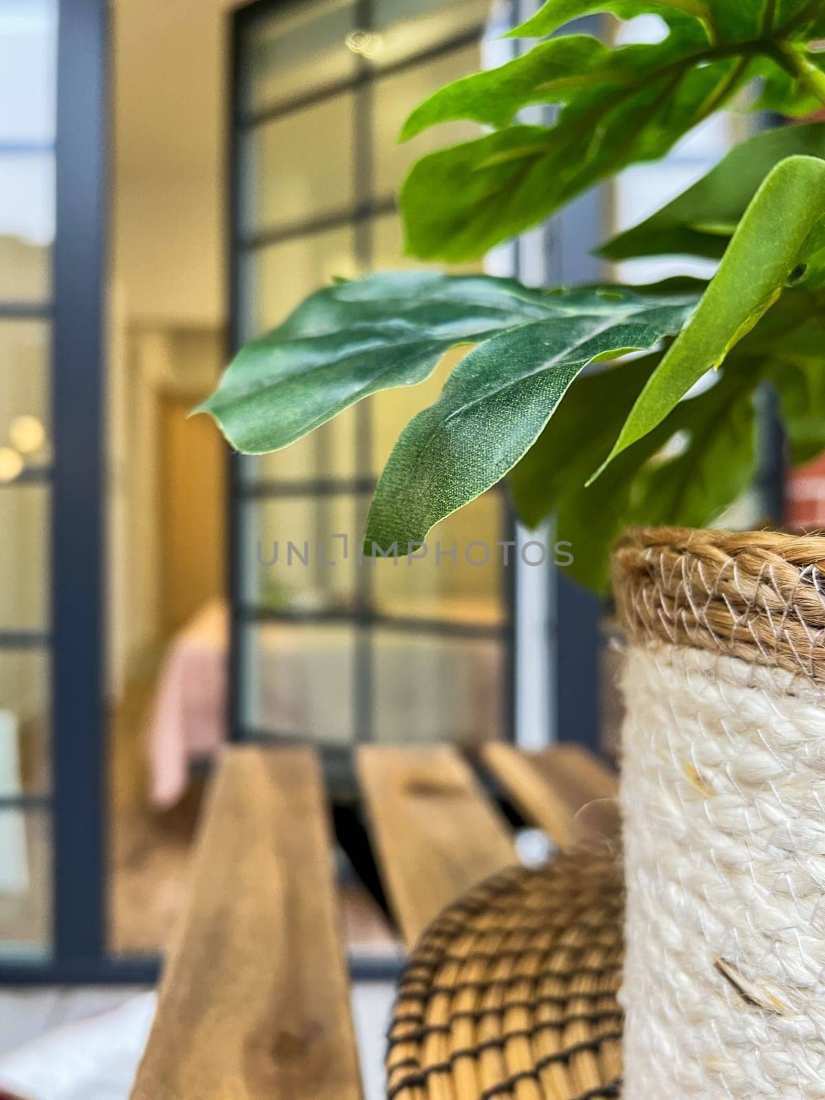 Balcony relax area with garden furniture, green flower, boho style, wood chair, bloor window, real photo