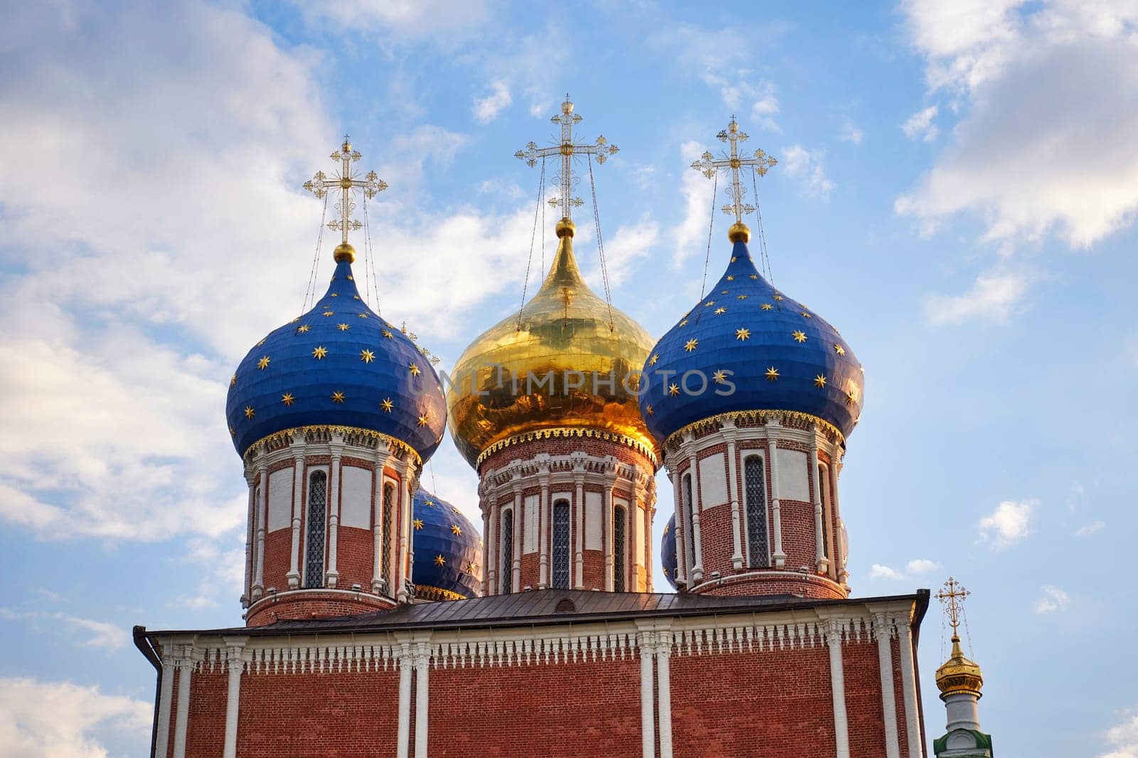 Famous Russian Orthodox Cathedral with golden and blue domes against blue sky with white clouds