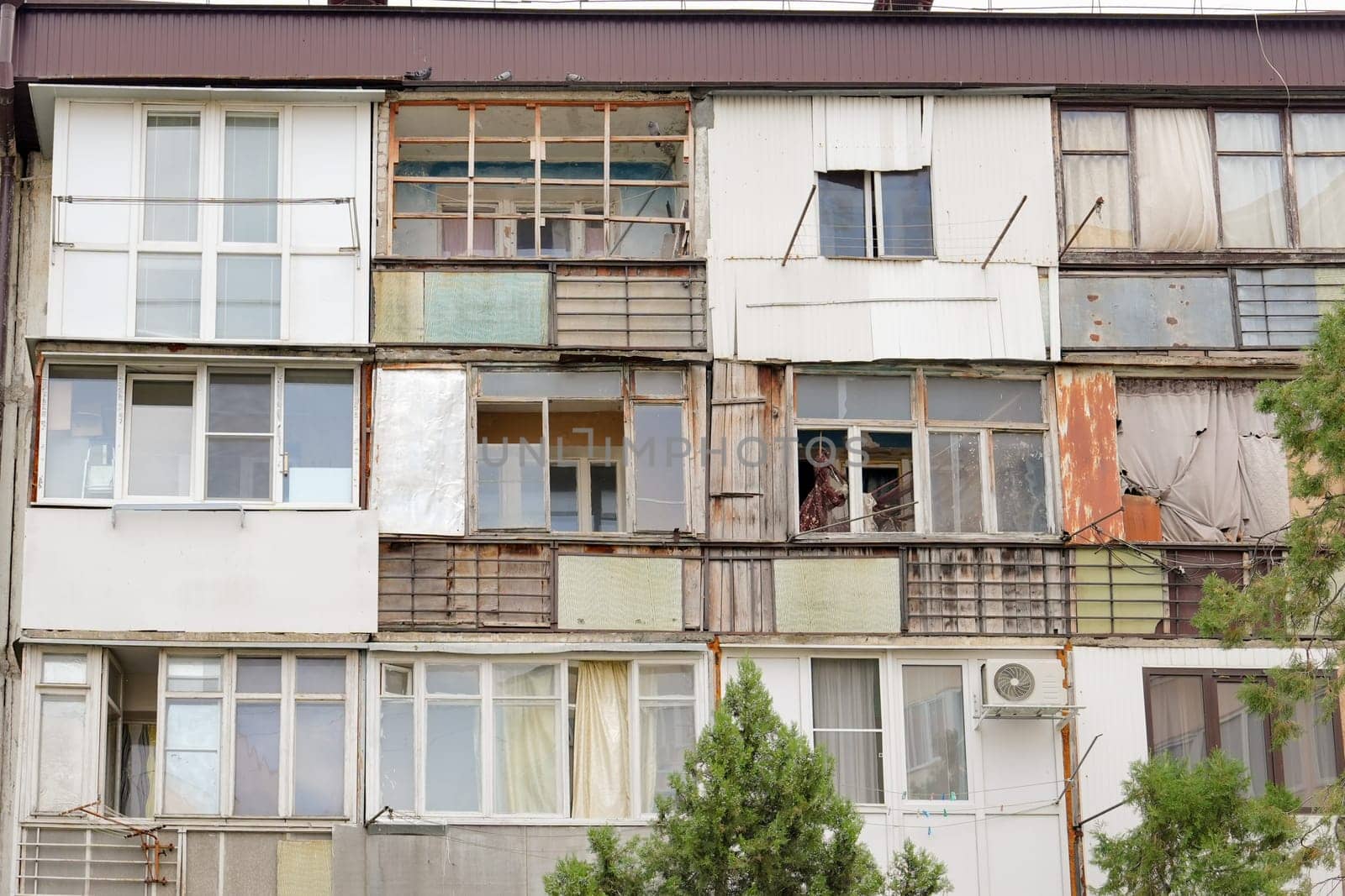 Ruined old poor dirty house with balconies