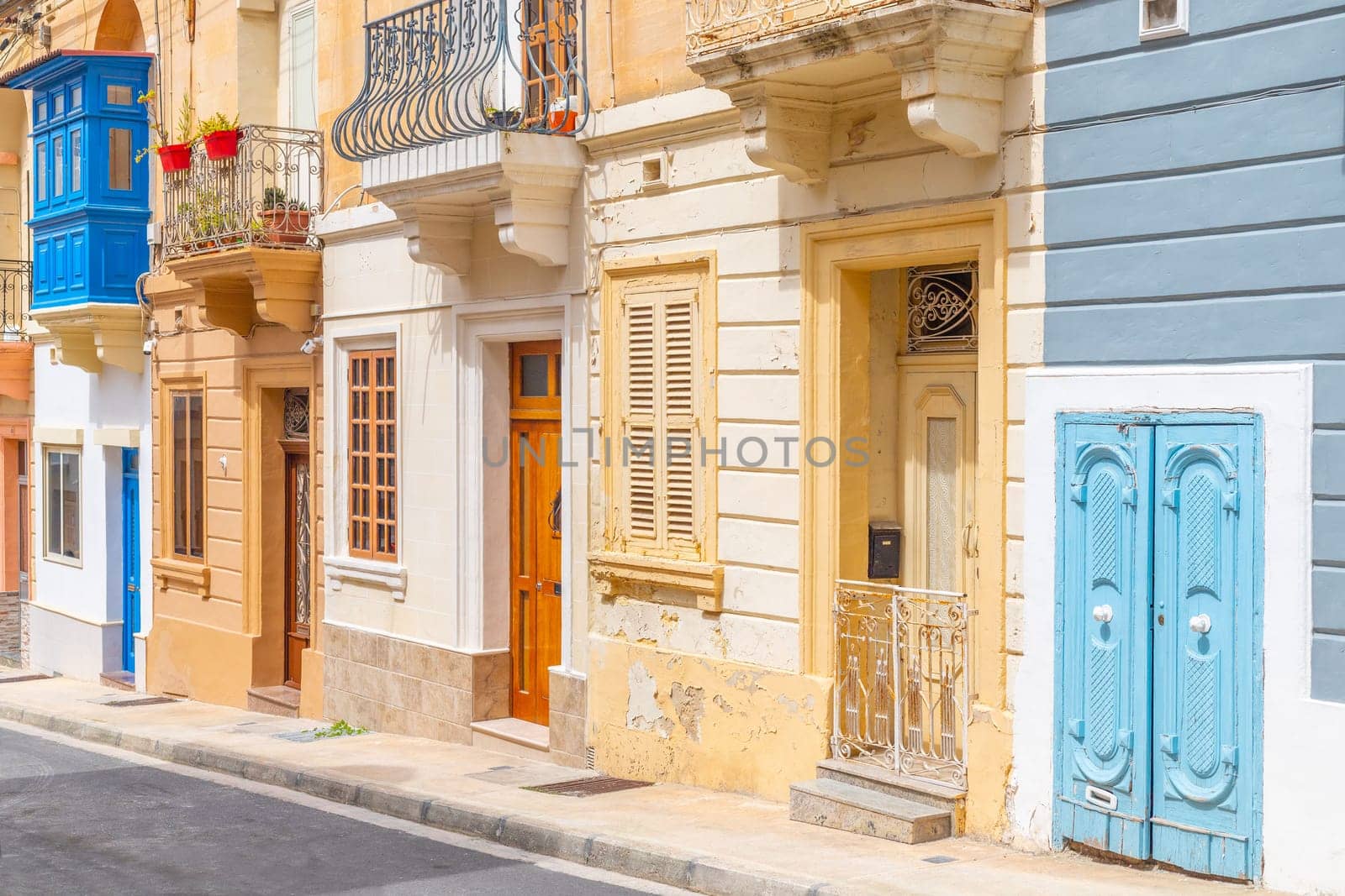 View of a typical Maltese street with old residential buildings in traditional architectural style, Malta.
