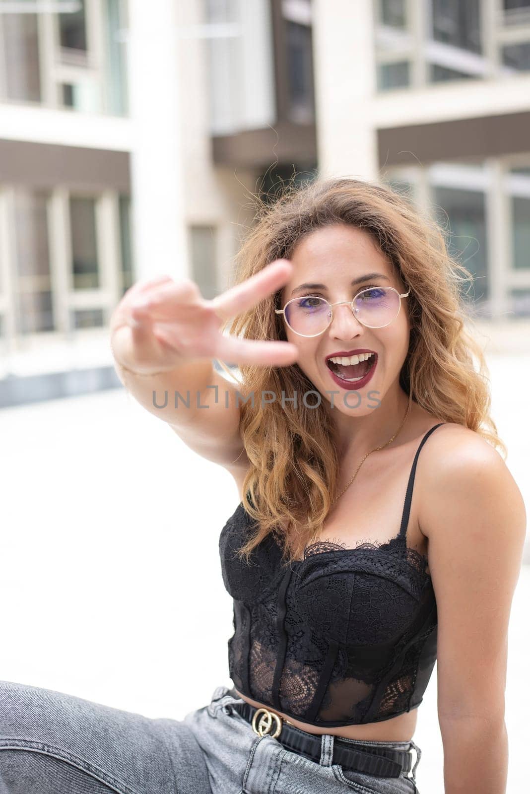 happy young woman showing victory sign