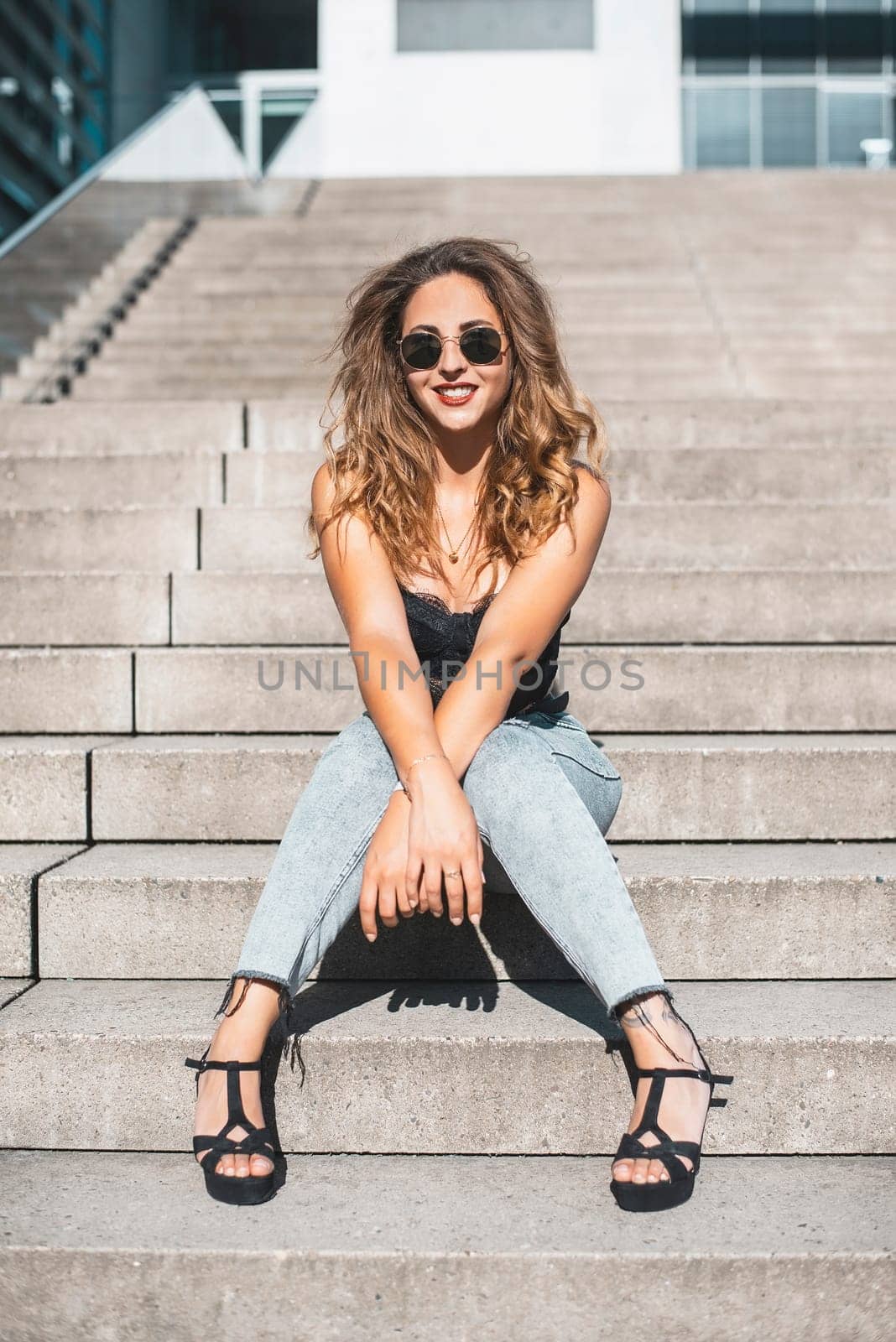 happy young woman with sunglasses in the city