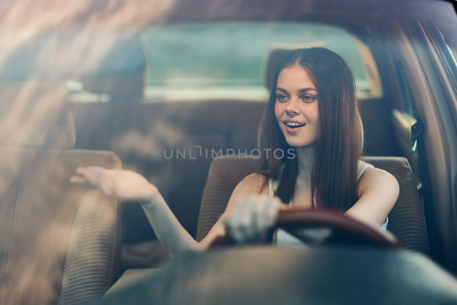 Cheerful young woman driving a car, exuding joy and confidence, dressed stylishly, against a green background, portraying the themes of freedom, adventure, and enjoyment.