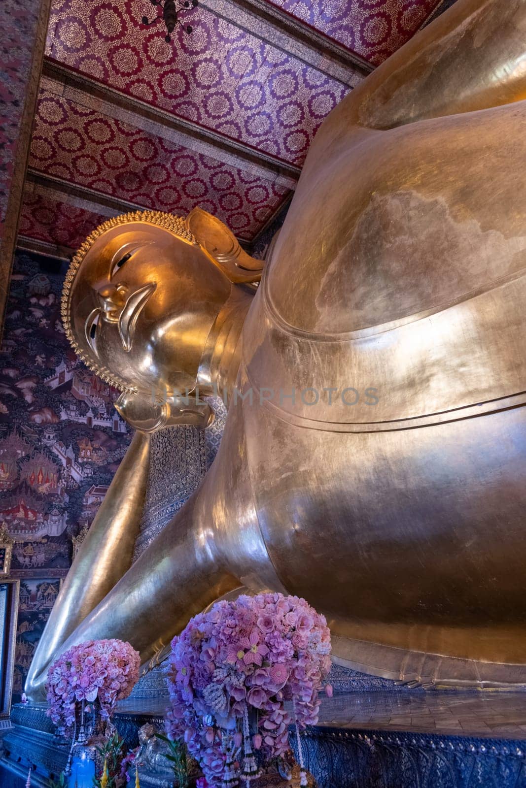 A breathtaking view of the magnificent golden Reclining Buddha at the historic Wat Pho temple in Bangkok