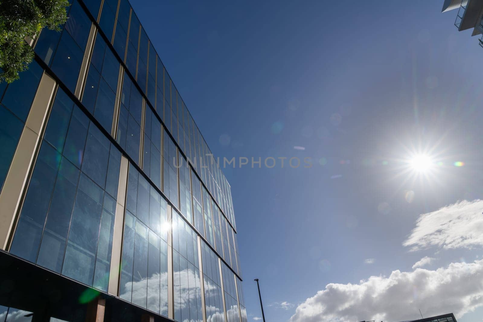 Tauranga urban street scene sun flare above exterior windows of urban commercial building new Zealand.