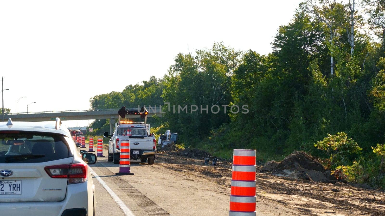 Mont-Tremblant QC Canada - 22.09.2024: Single File Traffic Cones on Road During Daytime for Construction Safety and Traffic Management.