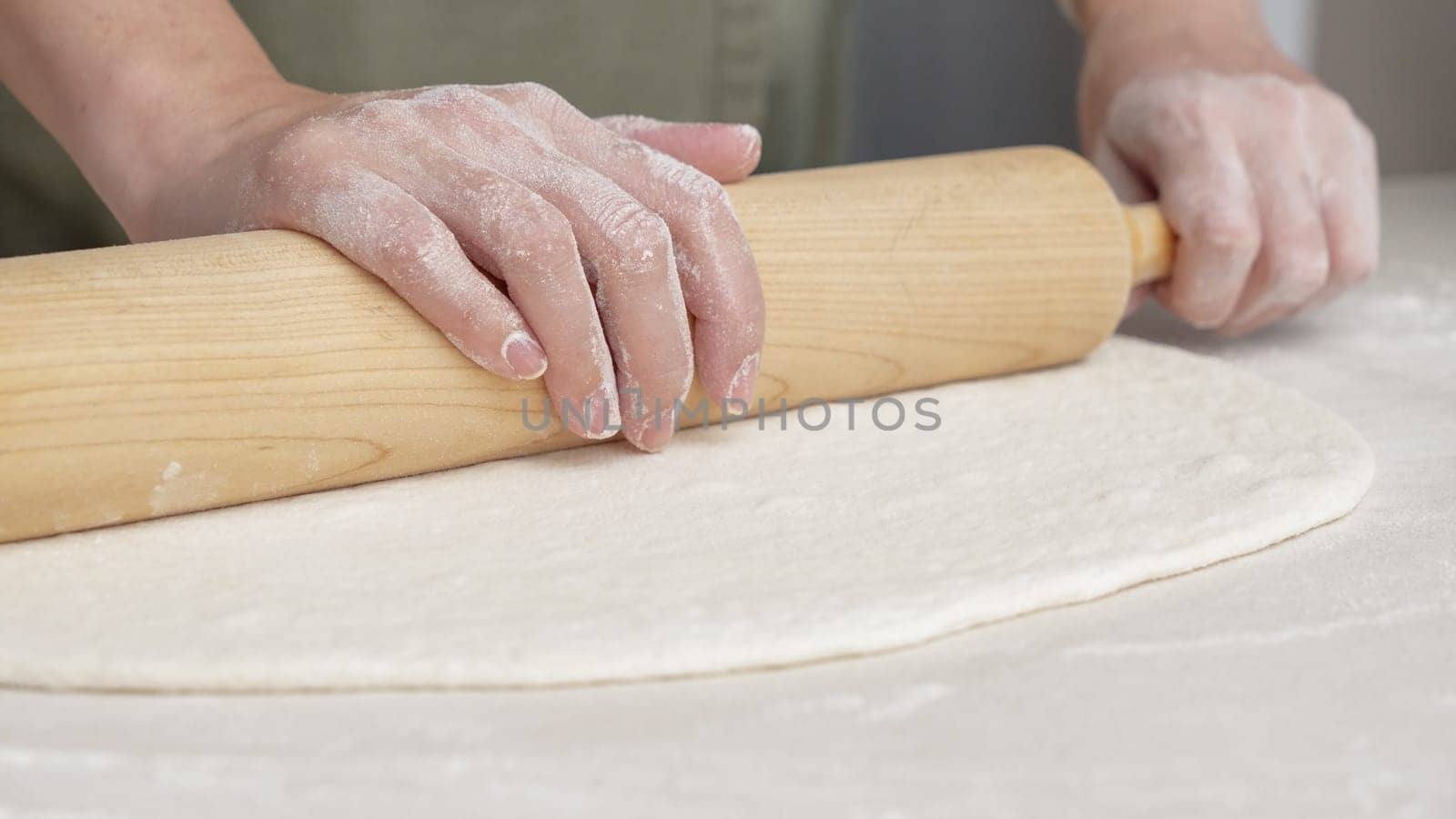 Hands Shaping the dough into ball by hand. chef Preparing the dough for baking pizza bread in the restaurant, baking.