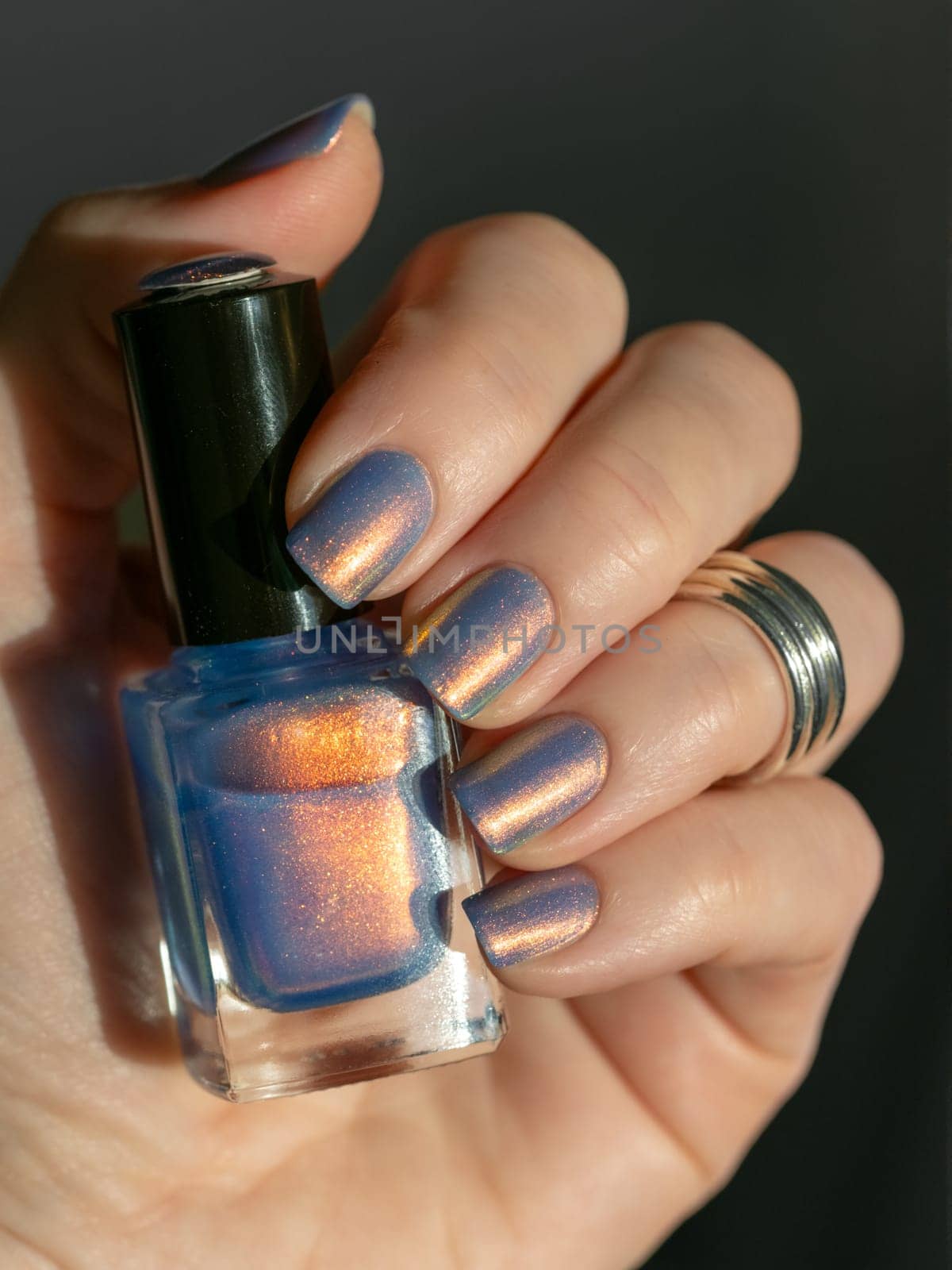 Close-Up of Nail Polish on Well-Groomed Nails with chrome powder effect nail polish in blue and pink colors