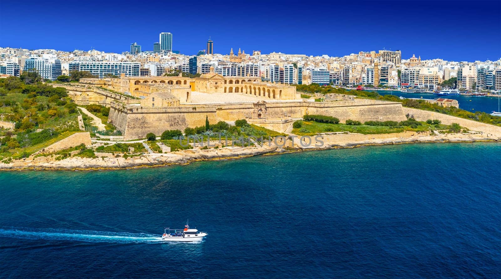 Picturesque panorama with ship passing Manoel Island fortress and Sliema in the background, Malta