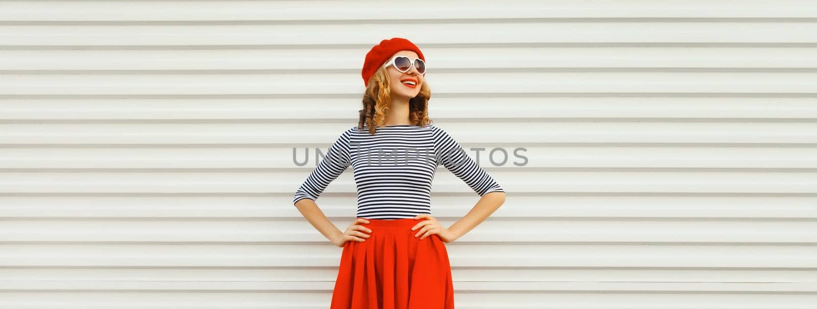 Beautiful happy smiling young woman, pretty girl in red skirt, french beret, heart shaped glasses posing on white background