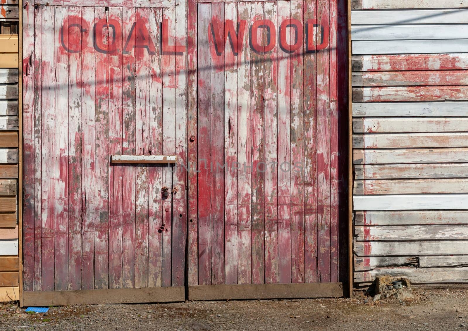 Mangaweka New Zealand - November 30 2011; Coal & Wood faded sign on facade of old industrial buildings