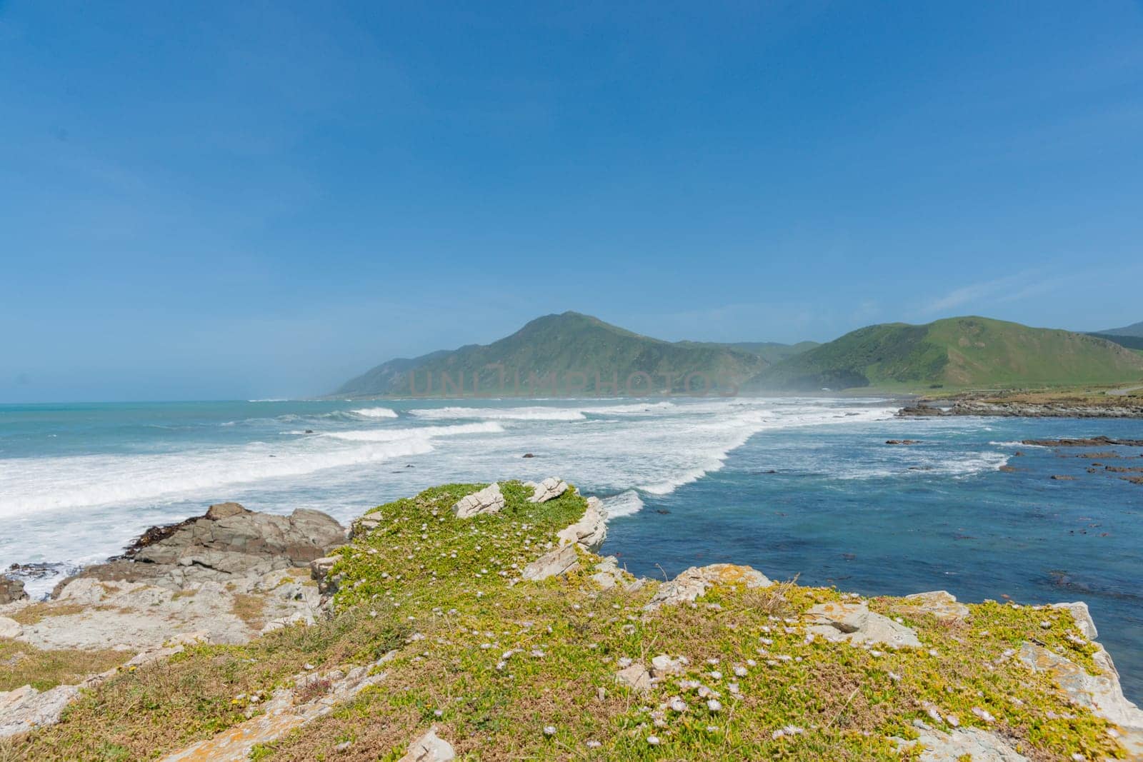 Rocky Wairarapa coast al edge with land.