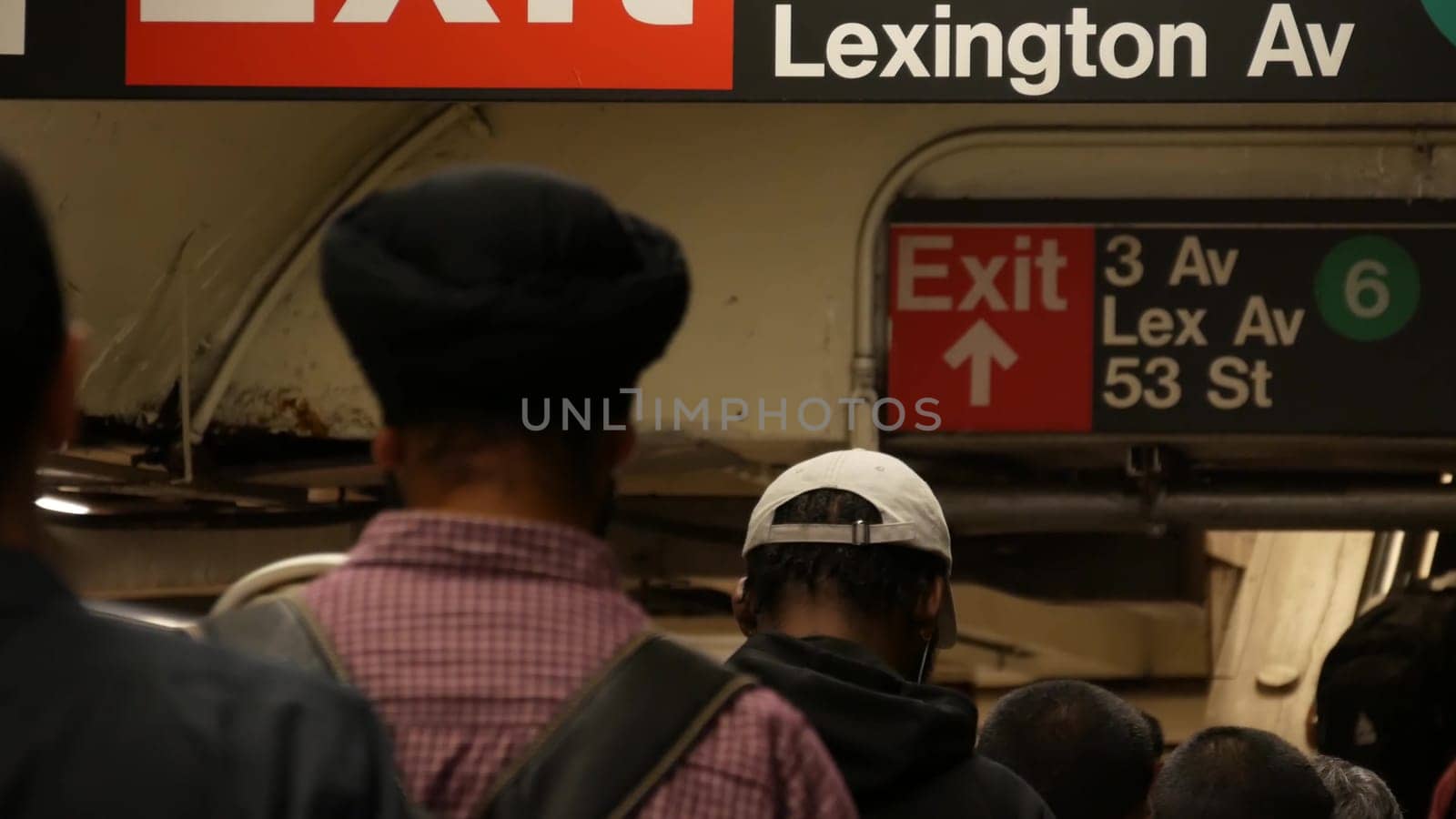 New York City, United States - 31 Aug 2023: Subway station interior, Lexington avenue sign. Manhattan underground metropolitan. Metro transport navigation. Public passenger railway. People, escalator.