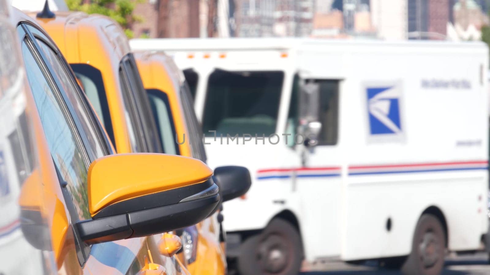 New York City, United States - 1 Sept 2023: Row of yellow taxi cars on street, Queens. Taxi cab on avenue, Long Island. Medallion taxicab. Manhattan Midtown urban skyline cityscape. High-rise building
