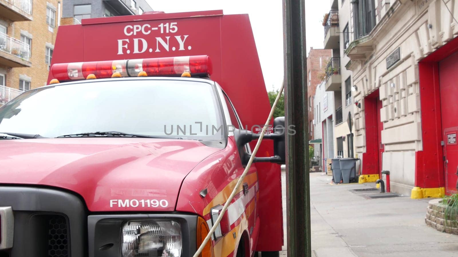 New York City, United States - 30 Aug 2023: NYFD car, USA fire department truck, american firefighters vehicle or fire fighter engine on NYC street. Firemen station red gates, FD house or hall. Queens