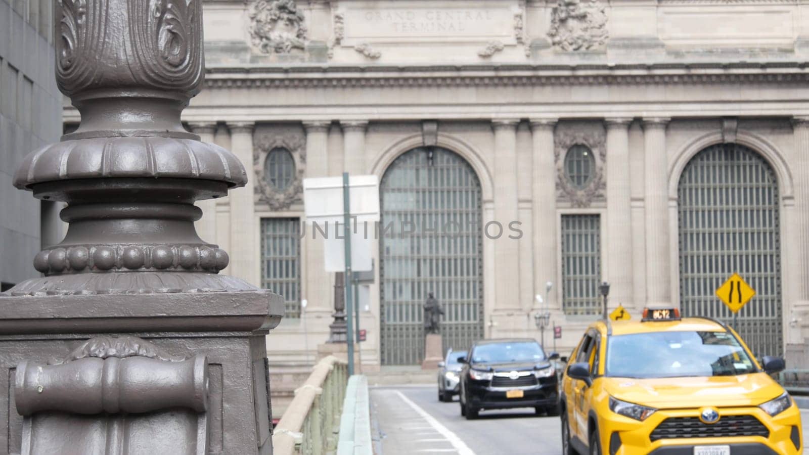 New York City, United States - 4 Sept 2023: Grand Central Terminal railway station building, 42 street. Manhattan Midtown. Yellow taxi cab, car transport on bridge, USA. American urban road traffic.