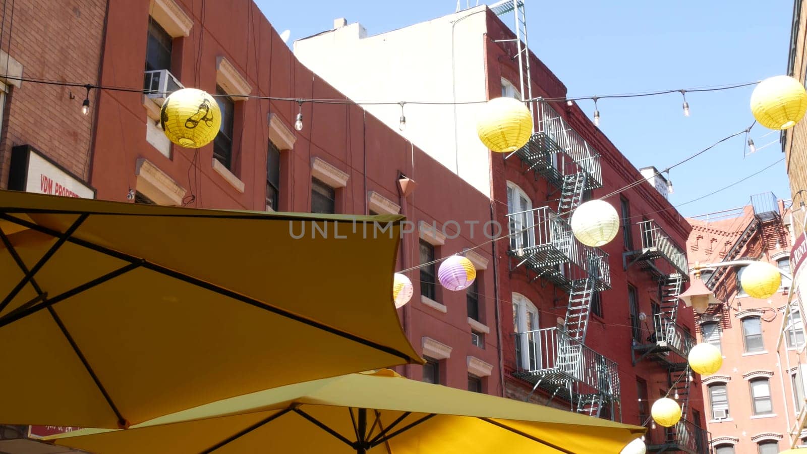 New York City, United States - 14 Sept 2023: Manhattan Chinatown Doyers street, chinese ethnic district building architecture, USA. Brick houses, paper lanterns, little China town. Fire escape ladder.