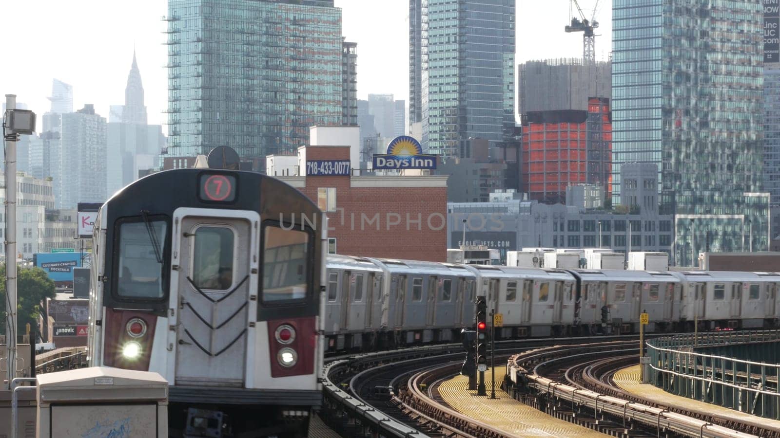 New York City, United States - 2 Sept 2023 Subway station. Metro train public transportation platform. Elevated railway, Queens passenger railroad traffic, Long Island skyline. Chrysler building.