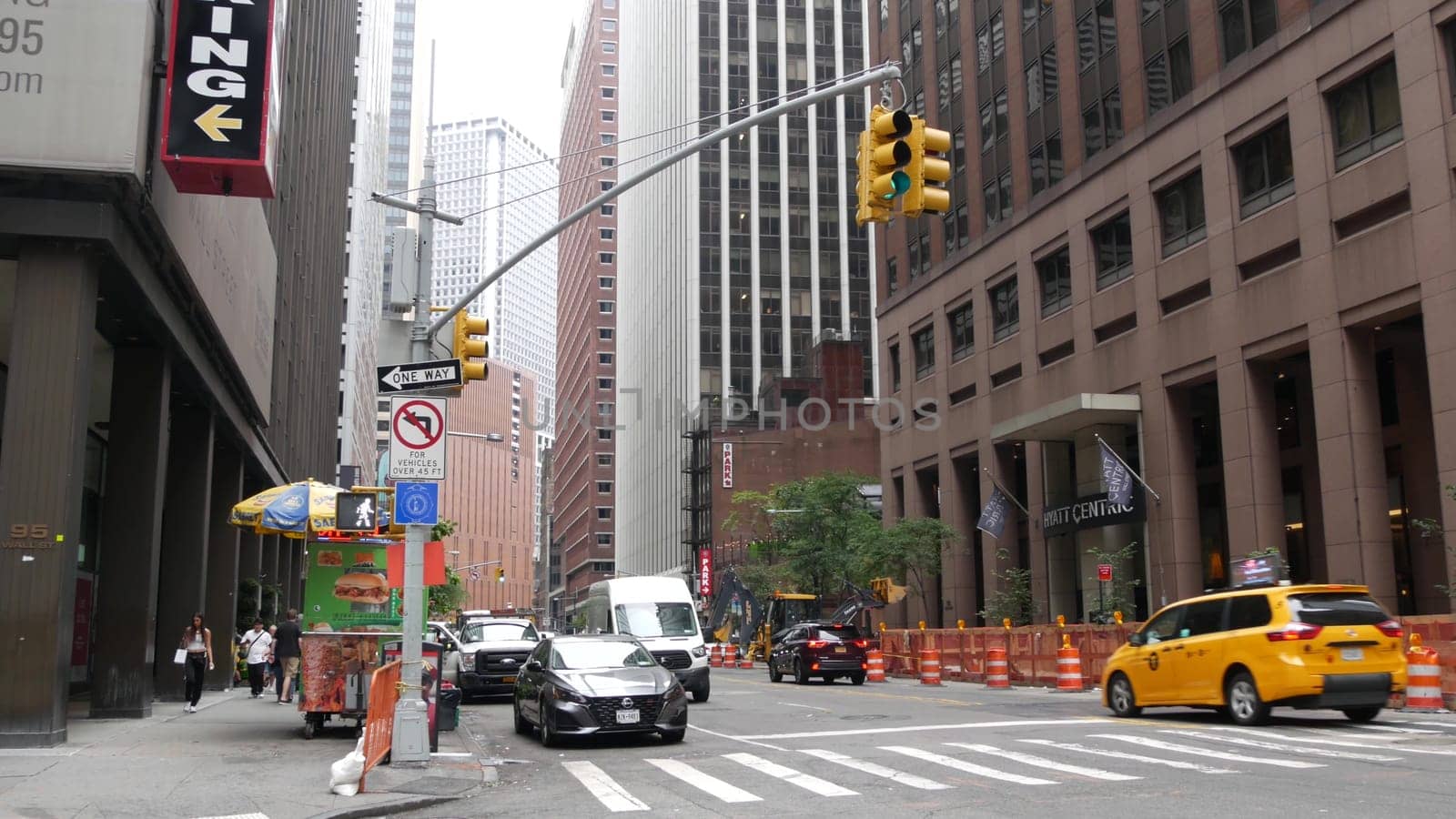 New York City, United States - 9 Sept 2023: Manhattan Downtown Financial District Water street crossroad intersection. USA NY city life. Urban road car traffic. Yellow taxi. People pedestrian, zebra.