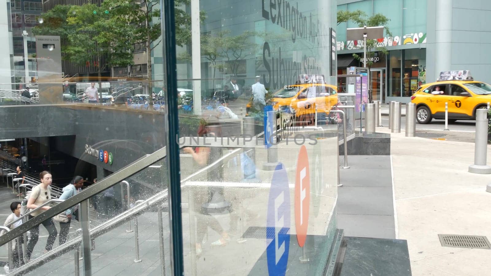 New York City, United States - 11 Sept 2023: Manhattan Midtown Lexington avenue, United States. People pedestrian exit underground subway station, stairs on 53 street, urban USA. Metro entrance sign.