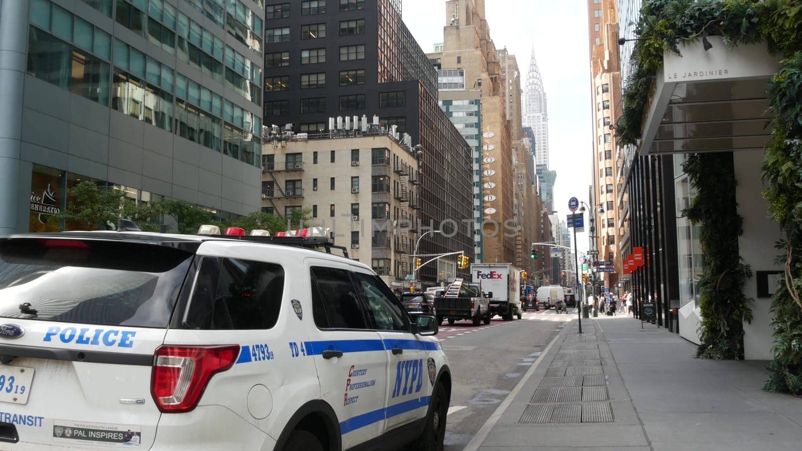 New York City, United States - 11 Sept 2023: Police patrol car, USA NYPD, 911 vehicle, Manhattan Midtown street traffic. American cop auto on Lexington avenue. Urban road transport. Chrysler Building.