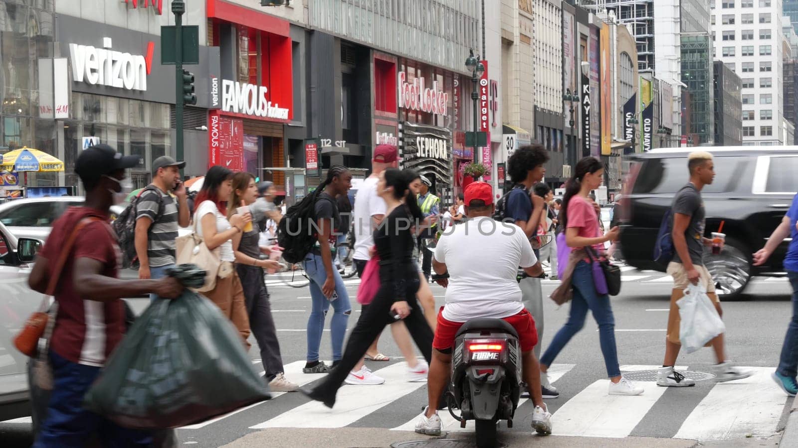 New York City, United States - 29 Aug 2023: Manhattan Midtown 34 street. Herald Square, Broadway, Sixth 6 Americas avenue, USA. People, zebra crosswalk. Road traffic Control Police guard, NYPD flagger
