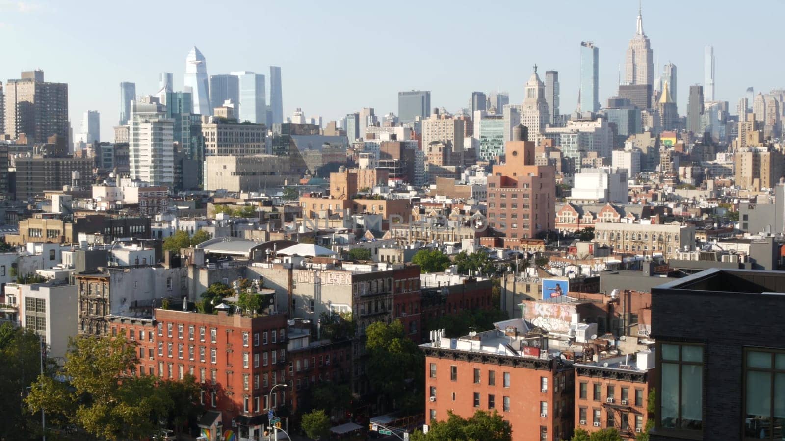 New York City, United States - 7 Sept 2023: Manhattan skyline cityscape. Empire State Building, Hudson Yards. Rooftop, residential house roof. Urban street architecture. Midtown district, East Village