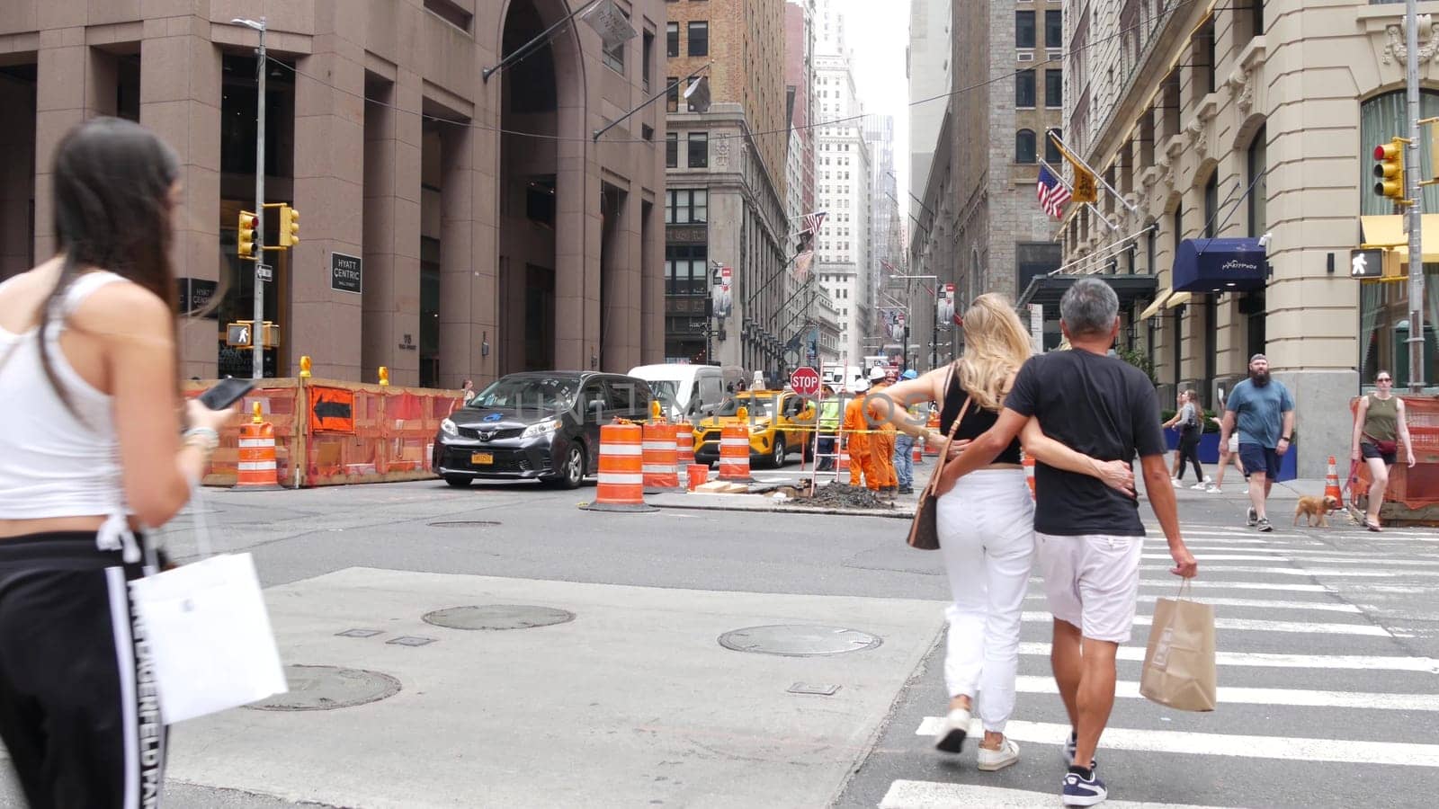 New York City, United States - 9 Sept 2023: Manhattan Downtown Financial District Water street crossroad intersection. USA Wall street. Urban road car traffic. Yellow taxi. People pedestrian, zebra.
