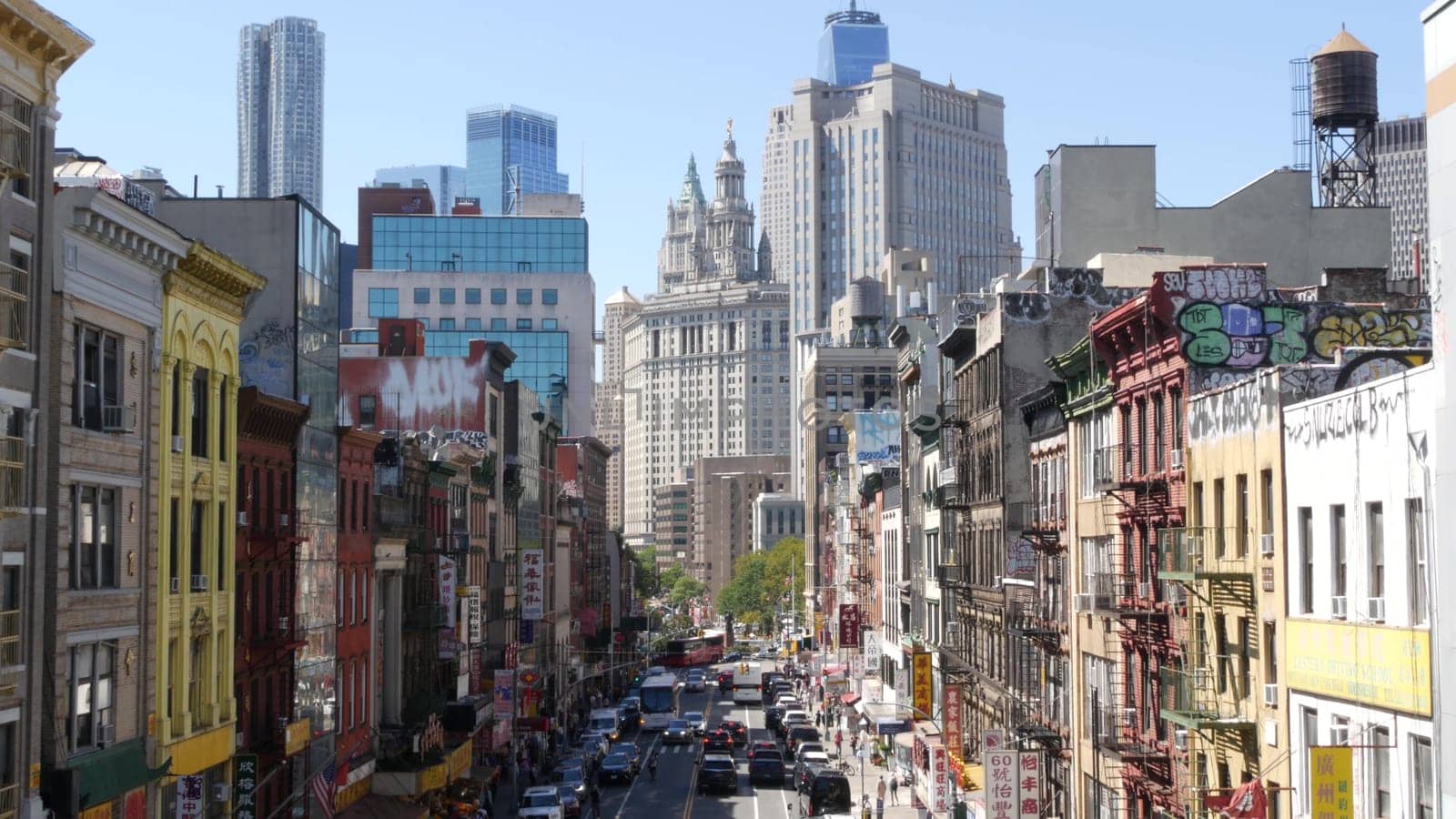 New York City, United States - 14 Sept 2023: Manhattan Chinatown East Broadway street, chinese ethnic district architecture, little Fuzhou, USA. World trade Center tower in Downtown. Manhattan Bridge.