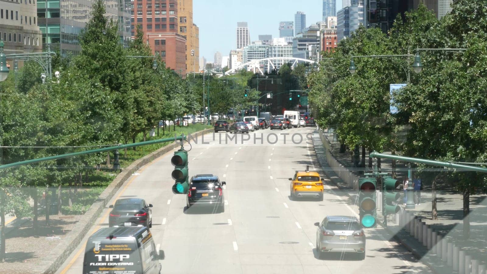 New York City, United States - 31 Aug 2023: Manhattan Downtown Financial District street crossroad intersection. Urban road car traffic. People pedestrian. World Trade Center memorial area. Skyline.