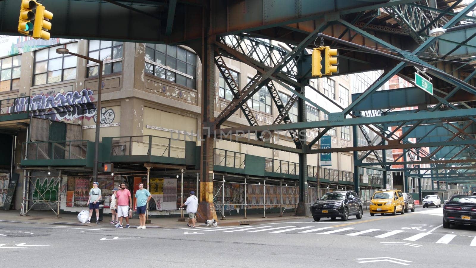 New York City, United States - 2 Sept 2023: Elevated subway over city street. Metropolitan bridge over road, Queens. Long Island overhead metro line, United States. Car under railway track. Queensboro