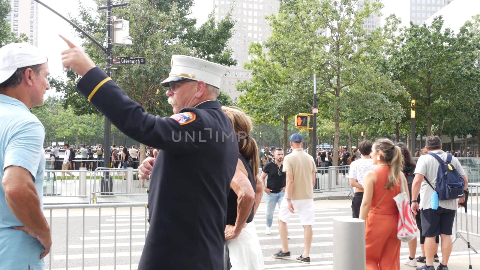 New York City, United States - 11 September 2023: Firefighters celebrate Patriot Day. FDNY officer near 911 Memorial Pools. Fire department old fireman talking to people on Manhattan Downtown, USA.