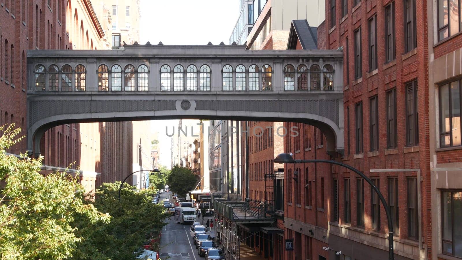New York City, United States - 1 Sept 2023: Chelsea Market skybridge. Industrial architecture, red brick building. Elevated sky bridge, Manhattan landmark, USA. Meatpacking district street, High Line.