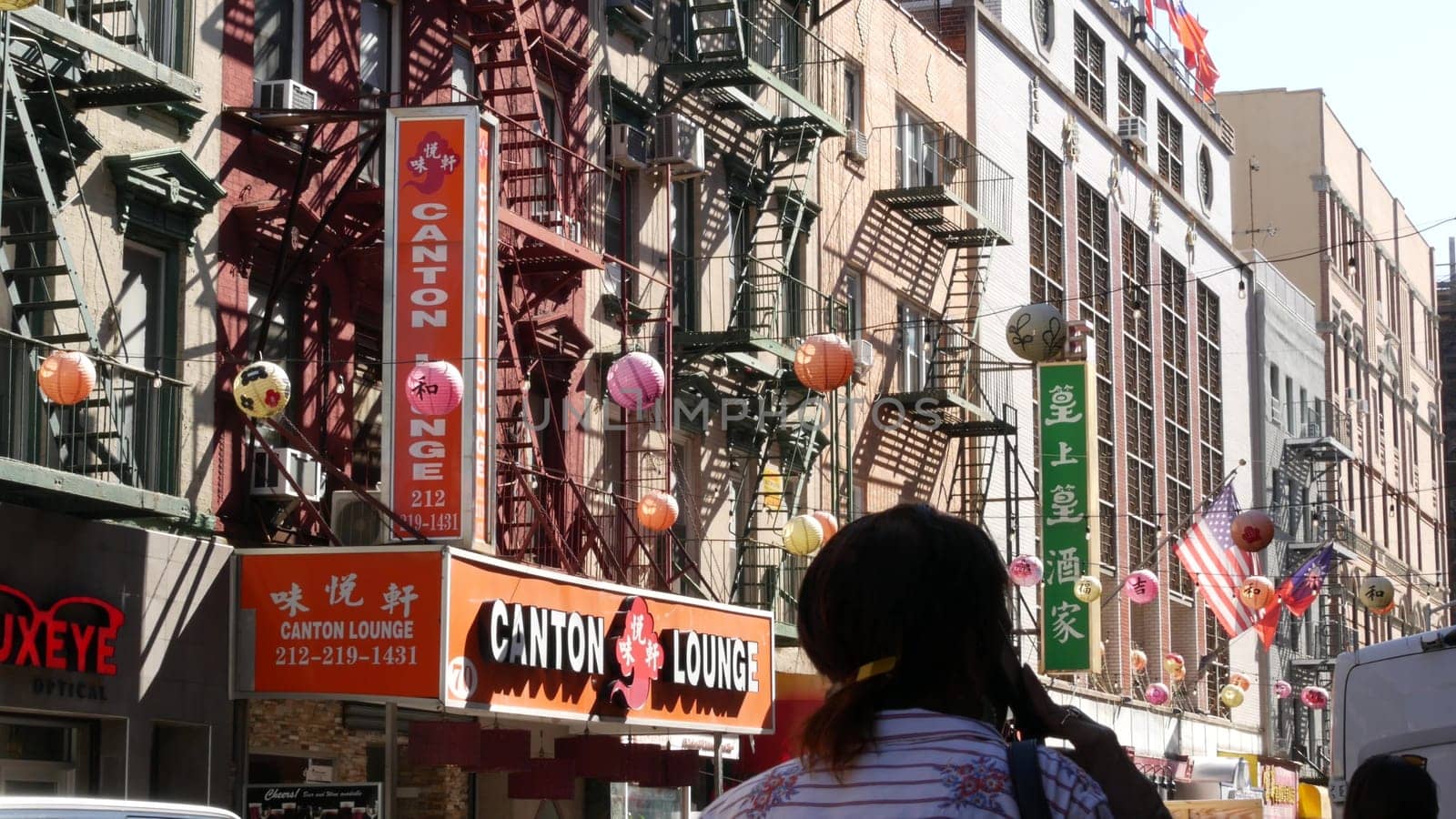 New York City, United States - 14 Sept 2023: Manhattan Chinatown Mott street, chinese ethnic district buildings architecture, USA. Red round paper lanterns, people and hieroglyph signs. Little China.