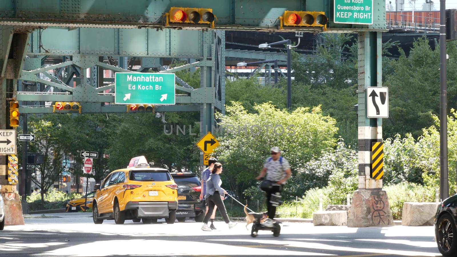 New York City, United States - 2 Sept 2023: Elevated subway over city street. Metropolitan bridge over road, Queens. Long Island overhead metro line, United States. Car under railway track. Queensboro