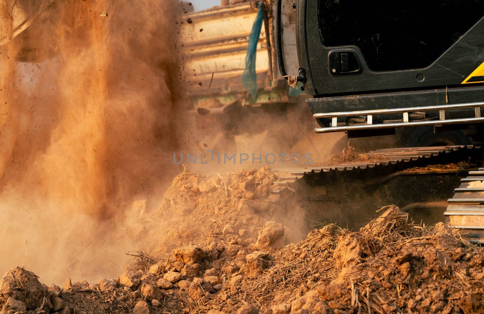 Close-up of excavator at construction site. Backhoe digging soil for earthwork and construction business. Excavating machine at work. Heavy machinery for earth moving and construction site development