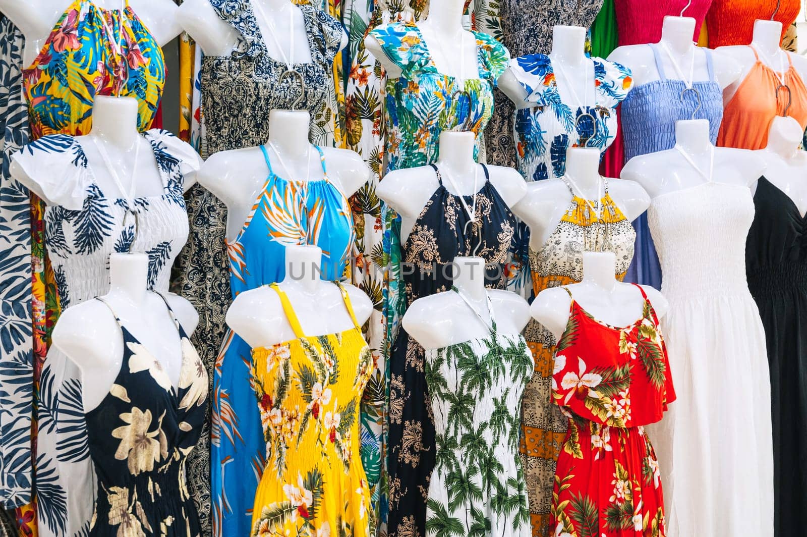 women's colorful summer dresses on mannequins are sold on the market in Asia