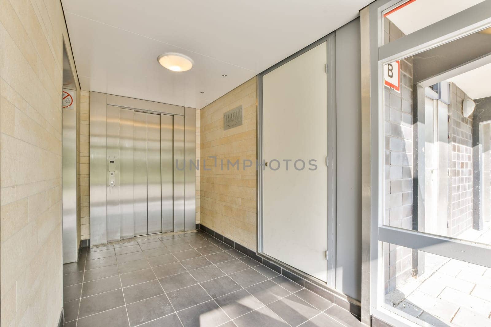 A sleek, modern indoor elevator lobby featuring smooth surfaces, minimalist design, and bright lighting that creates an inviting atmosphere.