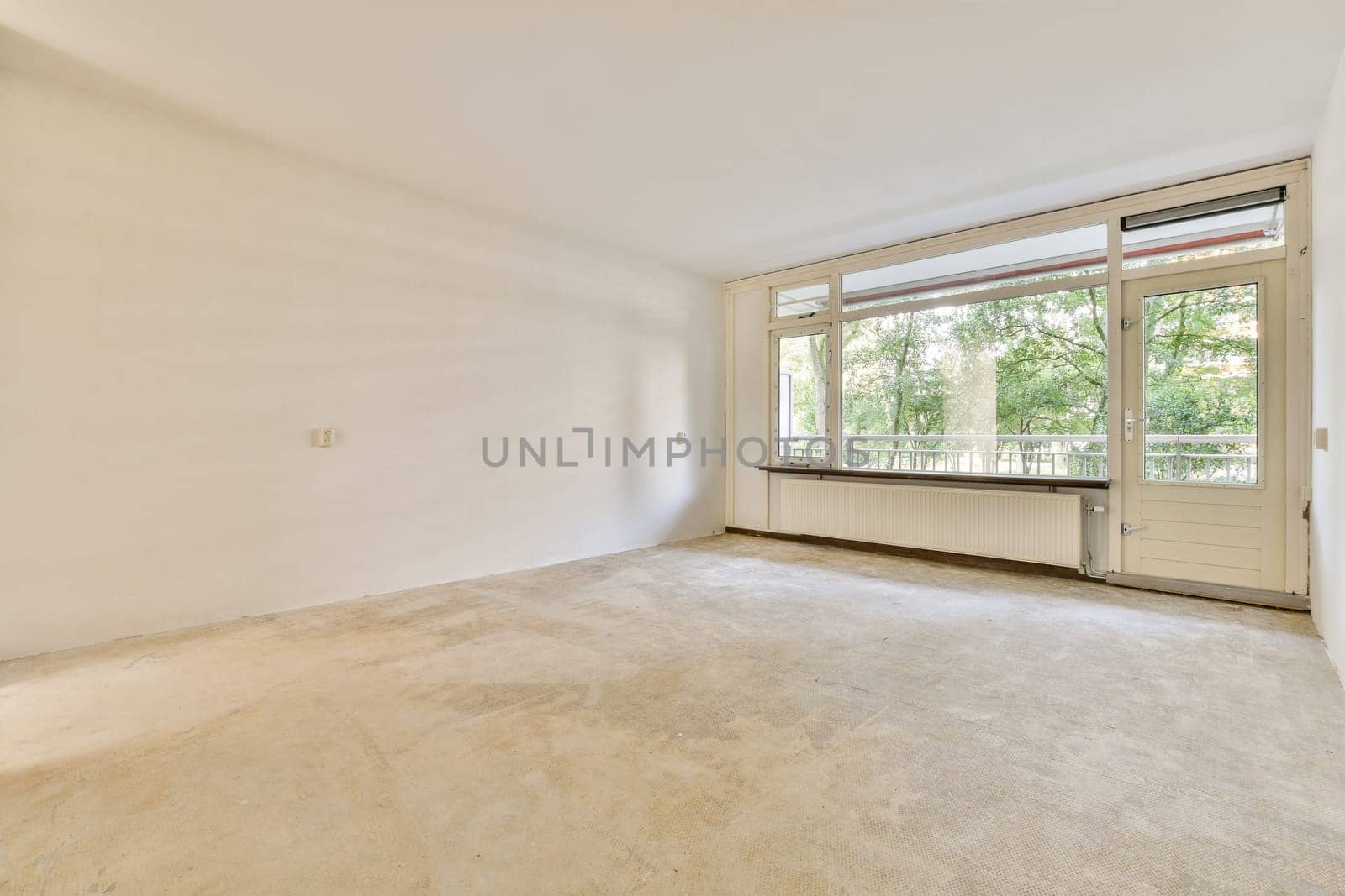 A spacious, empty interior showcasing large windows that invite natural light, creating a serene atmosphere perfect for customization.