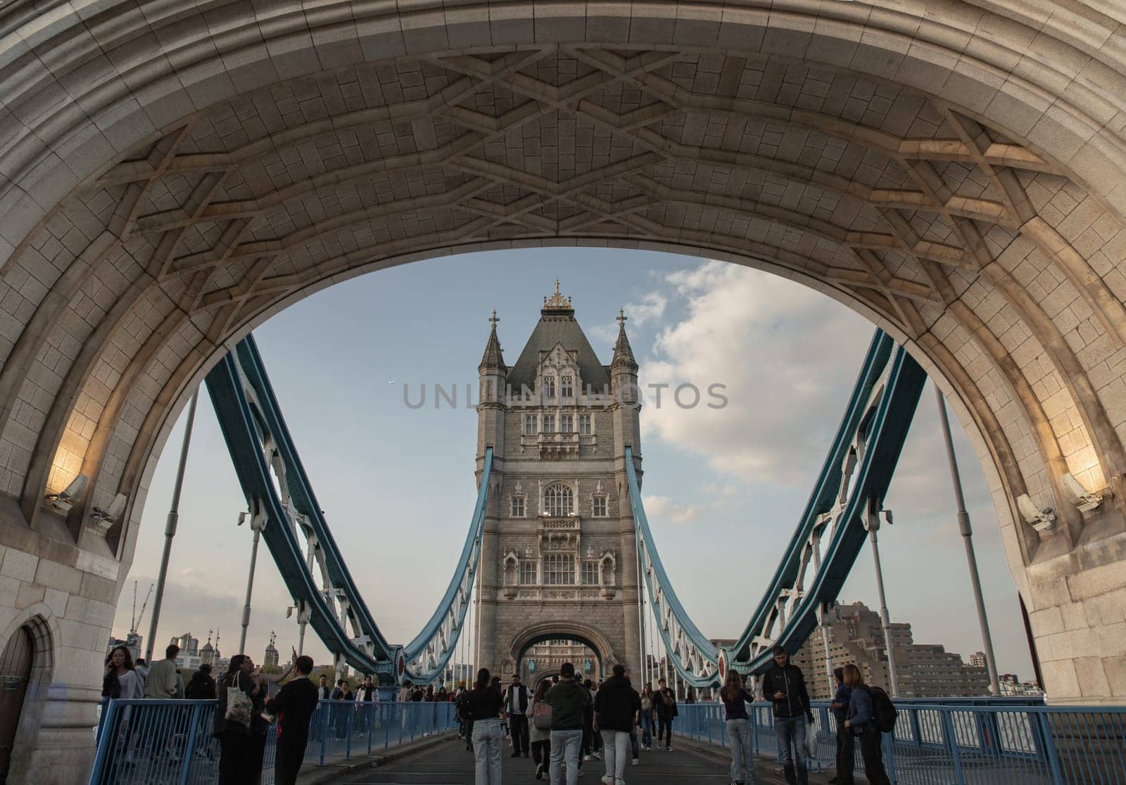 London, UK - Apr 27, 2025 - Crowd of people visit Stunning view of The Iconic Tower Bridge with sky in the background. Famous Tower Bridge is Bascule bridge in London, use it as your Wallpaper, Poster and Copy space, Selective focus.