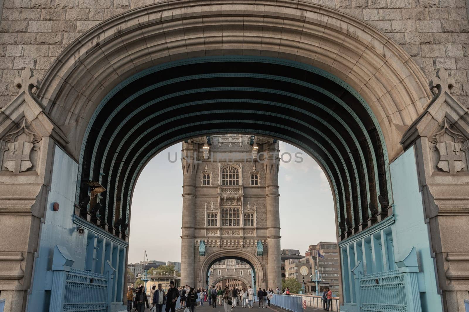 London, UK - Apr 27, 2025 - Crowd of people visit Stunning view of The Iconic Tower Bridge with sky in the background. Famous Tower Bridge is Bascule bridge in London, use it as your Wallpaper, Poster and Copy space, Selective focus.