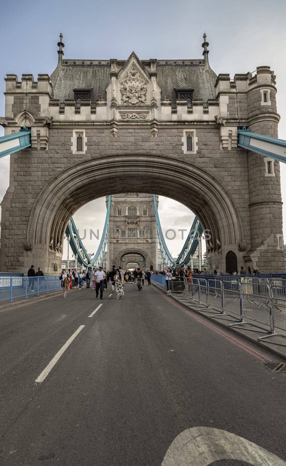 London, UK - Apr 27, 2025 - Crowd of people visit Stunning view of The Iconic Tower Bridge. Famous Tower Bridge is Bascule bridge in London, use it as your Wallpaper, Poster and Space for text, Selective focus.