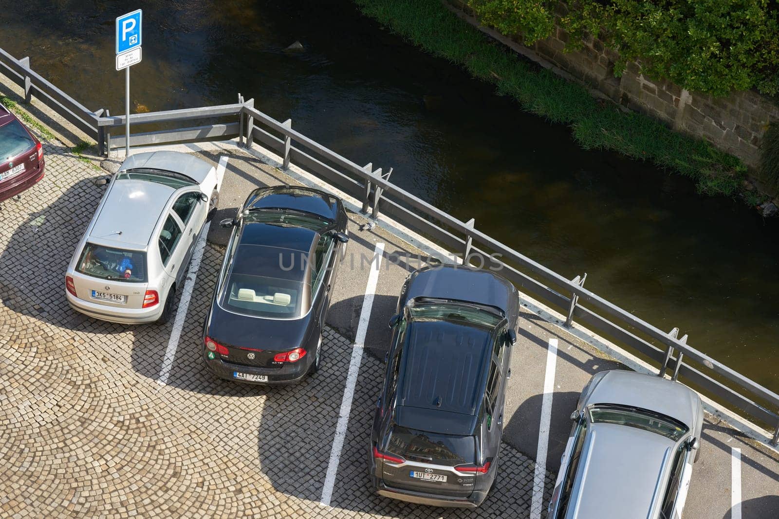 Karlovy Vary, Czech Republic – April 20, 2025: Public parking lot at the river Tepla in the city center of Karlovy Vary in the Czech Republic seen from above
